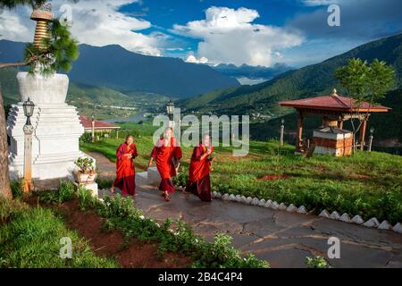 Nuns at Sangchhen Dorji Lhendrub Choling Nunnery a Buddhist Nuns College and temple stupa Punakha Bhutan. Sangchchen Dorji Lhuendrup nunnery is a larg Stock Photo