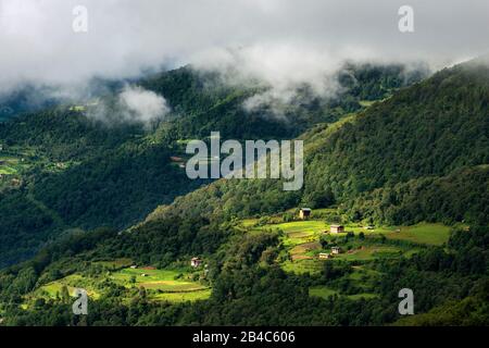 Trongsa landscape Pele La Pass, rural winding road to Trongsa passing through agricultural landscape Bhutan Stock Photo