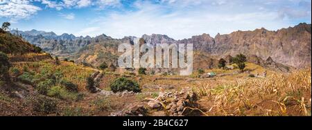 Gorgeous panorama view of the fields of intensive terrace cultivation surrounded by the huge barren mountain peaks, walls and cliffs. Santo Antao Island, Cape Verde. Stock Photo