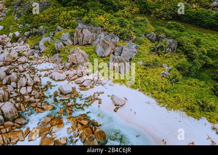 Aerial view of Seychelles tropical Marron beach at La Digue island. White sand beach with turquoise ocean water and granite rocks. Stock Photo