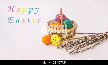 Easter eggs. Happy easter card. Multi-colored Easter eggs and rabbit. Easter eggs on a light background. Easter greetings. Happy easter. Lettering Hap Stock Photo