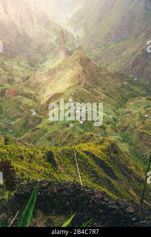 Mountain peaks of Xo-Xo valley in sun light. Local village in the valley. Many agava plants grow on the steep stony slopes. Santa Antao island, Cape Verde. Stock Photo