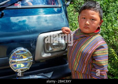 Portrait of cute little boy with traditional clothign in a festival in Ugyen Pema Woedling Zangthopelri temple Paro Bhutan Stock Photo