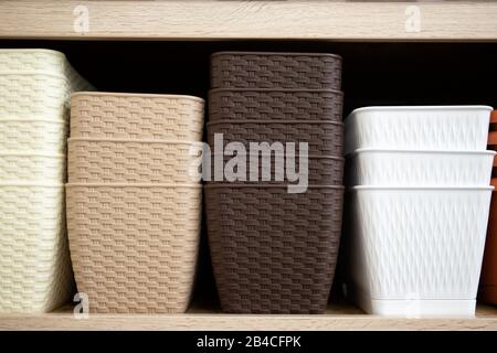 Shelf with plastic flower pots. Stock for flowers Stock Photo