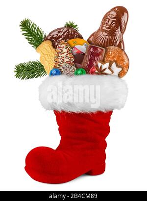 Red st nicholas day boot filled with chocolate santa claus cookies gingerbread cinnamon stars orange and green fresh fir branches isolated on white ba Stock Photo