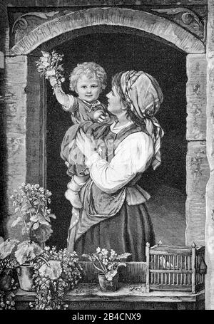 Welcome home: portrait of a toddler holding a bunch of flowers in the mother arms welcoming the father at home from the window Stock Photo