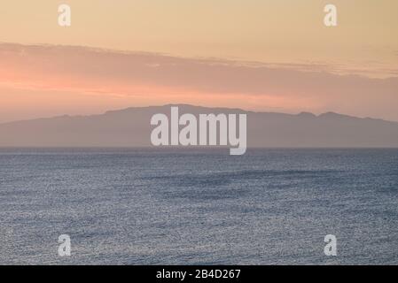 Spain, Canary Islands, Tenerife Island, Playa de Las Americas, elevated view towards La Gomera Island, sunset Stock Photo