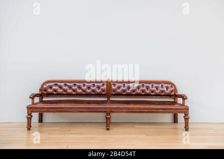 luxurious retro leather armchair on wooden floor Stock Photo