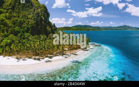 Pinagbuyutan Island, El Nido, Palawan, Philippines, aerial view of the tropical sandy beach with coconut palms and turquoise blue water