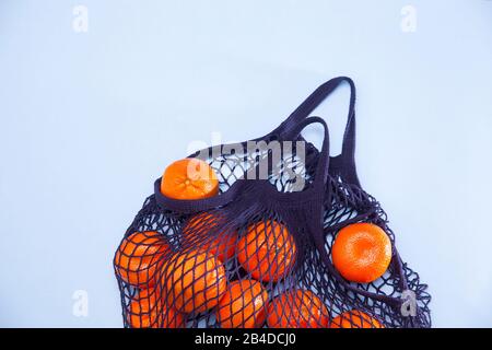 Net bag with many fresh ripe tangerines, closeup Stock Photo - Alamy