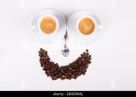 smiley made from cups of coffee on white background Stock Photo