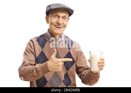 Elderly man holding a glass of milk and pointing isolated on white background Stock Photo