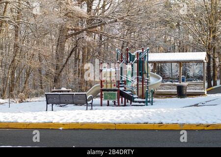 Newport News, VA/USA, February 21,2020: Playground and picnic area in an apartment complex covered in snow after a winter storm. Stock Photo
