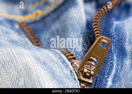 Open zipper of a worn out blue jeans Stock Photo