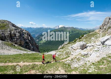 Valparole pass, Dolomites, Belluno province, Veneto, Italy, Europe. Hiker on the southwest side of the witch stone Stock Photo