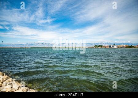 Paraglider on the sea. In the background the Velebit mountains. Stock Photo