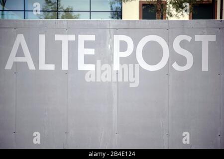 The inscription Alte Post on the gray wall of a parking lot border in Pirmansens. Stock Photo