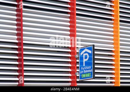 The architectural detail of the modern facade of a parking garage with a parking sign Stock Photo