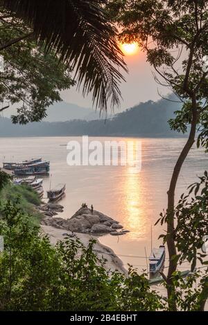 Laos, Luang Prabang, Riverboats on the Mekong River, sunset Stock Photo