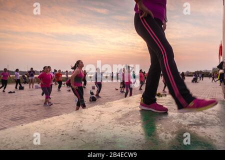 Laos, Vientiane, Mekong Riverfront, outdoor excercise class, dusk, no releases Stock Photo