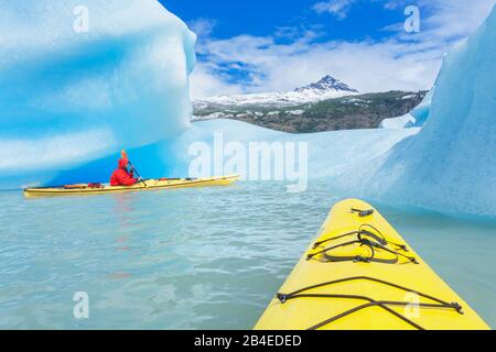 Kayaker paddles among icebergs, Torres del Paine National Park, Patagonia, Chile, South America Stock Photo