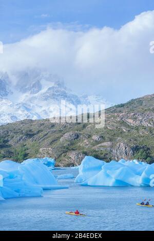 Kayakers paddles among icebergs, Torres del Paine National Park, Patagonia, Chile, South America Stock Photo