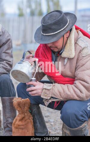 Cowboy pouring mate tea, Torres del Paine National Park, Patagonia, Chile, South America Stock Photo