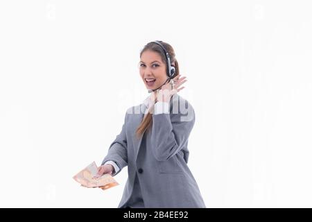 Female real estate agent holding euro bills and house keys Stock Photo