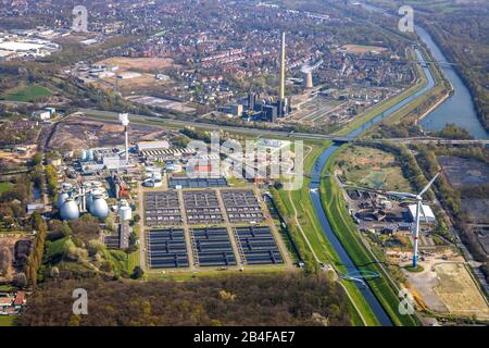 Aerial view of the sewage treatment plant Bottrop, Emscher river, Emscherkläranlage in Bottrop in the Ruhr area in the federal state of North Rhine-Westphalia, Germany. South of the Emscher stands the wind power plant on the storm yard. Stock Photo