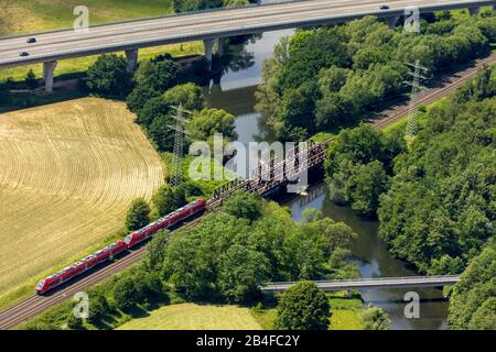Aerial view of the railway bridge with S-Bahn over the Ruhr and the Casparistrasse with A46 motorway in Oeventrop in Arnsberg in Sauerland in the state of North Rhine-Westphalia in Germany Stock Photo