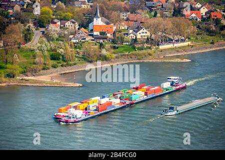 Aerial view of the cargo ship in front of the Rheinufer Götterswickerhamm am Rhein in Voerde in the state of North Rhine-Westphalia, Germany. Cargo ship in front of the Rhine. Stock Photo