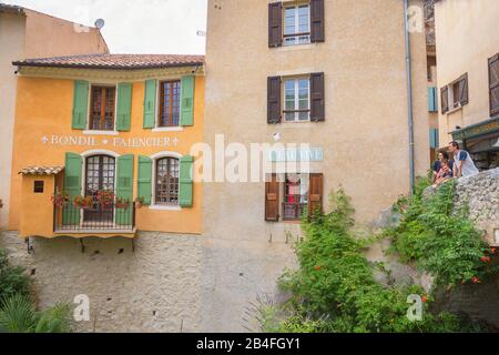 Tourists enjoying the view of Moustiers Sainte Marie, Moustiers Sainte Marie, Alpes de Haute Provence Stock Photo