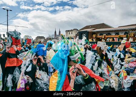 Europe, Switzerland, Basel, Traditional event, Basel Fasnacht, the largest in Switzerland, intangible cultural heritage of humanity, Cortège at Wettsteinplatz, Guggenmusik, Pfeifer clique with sujet 'Abfall' Stock Photo