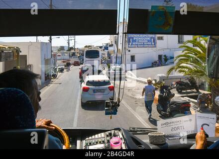 View from inside a tourist bus of the narrow, crowded street of shops and businesses at Fira, also known as Thira Greece, on the island of Santorini Stock Photo