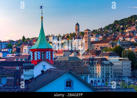 Aerial view over roofs and towers of Old Town of Zurich, the largest city in Switzerland at sunset. Stock Photo