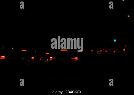 Abstract and blurred circles of lights of stop lights and night lights at night. Stock Photo