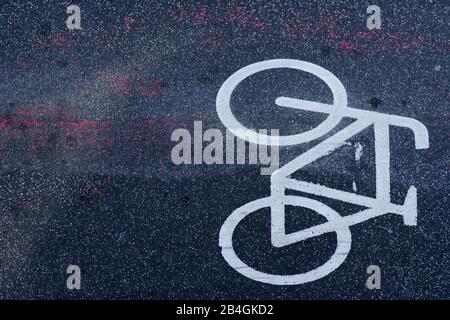 The top view of the road marking and the symbol of a bicycle path on the asphalt. Stock Photo