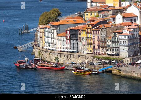 Traditional boats with barrels of wine, on the Douro River in the Portuguese city of Porto Stock Photo