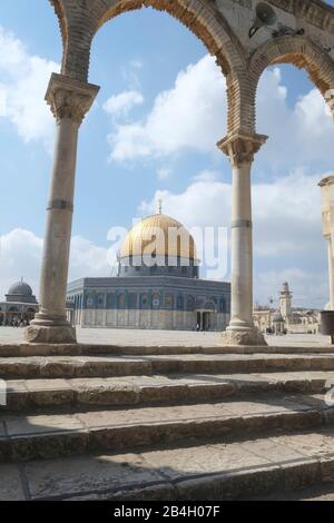 Israel, Jerusalem, Dome of the Rock. The jewel in the crown of Temple Mount / Al Haram Ash Sharif is the gold-plated Dome of the Rock, the enduring symbol of the city and one of the most photographed buildings on earth. As its name suggests, the dome covers a slab of stone sacred to both the Muslim and Jewish faiths. According to Jewish tradition, it was here that Abraham prepared to sacrifice his son. Islamic tradition has the Prophet Muhammad ascending to heaven from this spot Stock Photo