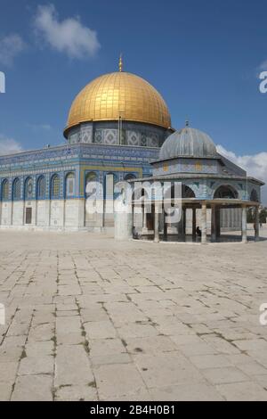 Israel, Jerusalem, Dome of the Rock. The jewel in the crown of Temple Mount / Al Haram Ash Sharif is the gold-plated Dome of the Rock, the enduring symbol of the city and one of the most photographed buildings on earth. As its name suggests, the dome covers a slab of stone sacred to both the Muslim and Jewish faiths. According to Jewish tradition, it was here that Abraham prepared to sacrifice his son. Islamic tradition has the Prophet Muhammad ascending to heaven from this spot Stock Photo