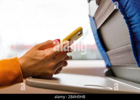 Addiction of social network, internet, nomophobia concept. Female using cellphone in public transportation, texting or reading message, checking news Stock Photo