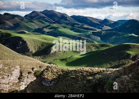 A beautiful view of a green landscape with mountains under the blue sky ...