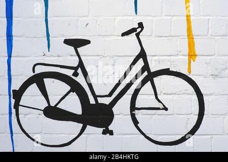 The drawing and the outline of a bicycle on a wall with color gradients. Stock Photo