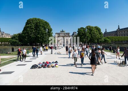 Tourists on the Allée Centrale in the Tuileries Garden overlooking the Arc de Triomphe du Carrousel towards the Louvre, Paris, France, Europe Stock Photo