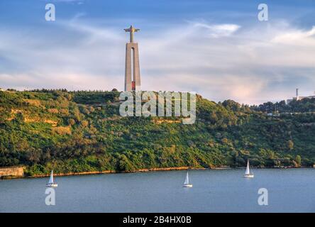 Christ statue at the harbor entrance over the Tagus, Lisbon, Portugal Stock Photo