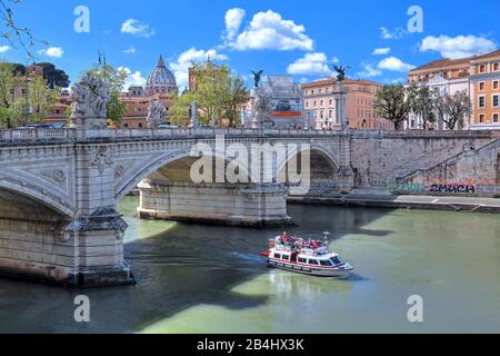 Excursion boat on the Tiber with Ponte Vittorio Emanuele II and the dome of St. Peter's Basilica, Rome, Lazio, Italy