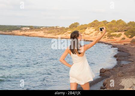 Couple young selfie photo in beach together vacation sunrise at Spain Stock  Photo - Alamy