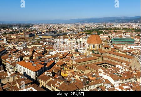 Italy, Florence, the Basilica di San Lorenzo in the center of the market district, on the left in the picture Basilica di Santa Croce Stock Photo