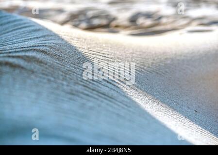Closeup of beach sand shaped by wind as wave, play with light and shadow, symbol image Baltic Sea Stock Photo