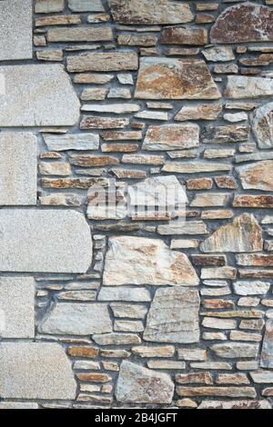 A strong limestone wall in ochre tones. with some larger blocks on the left. for background Stock Photo